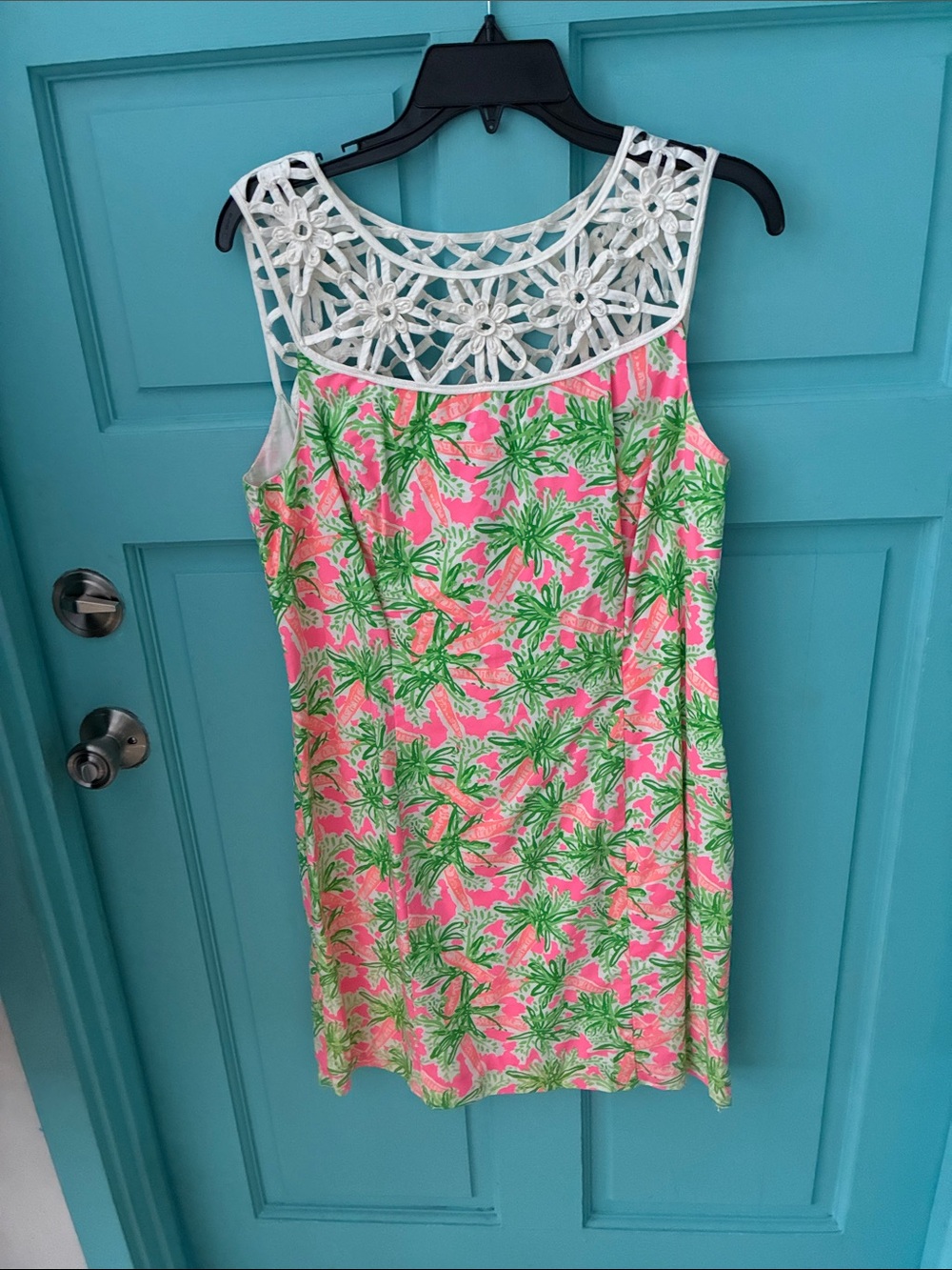 Lillie Pulitizer skeevless with open flower print neckline trim.